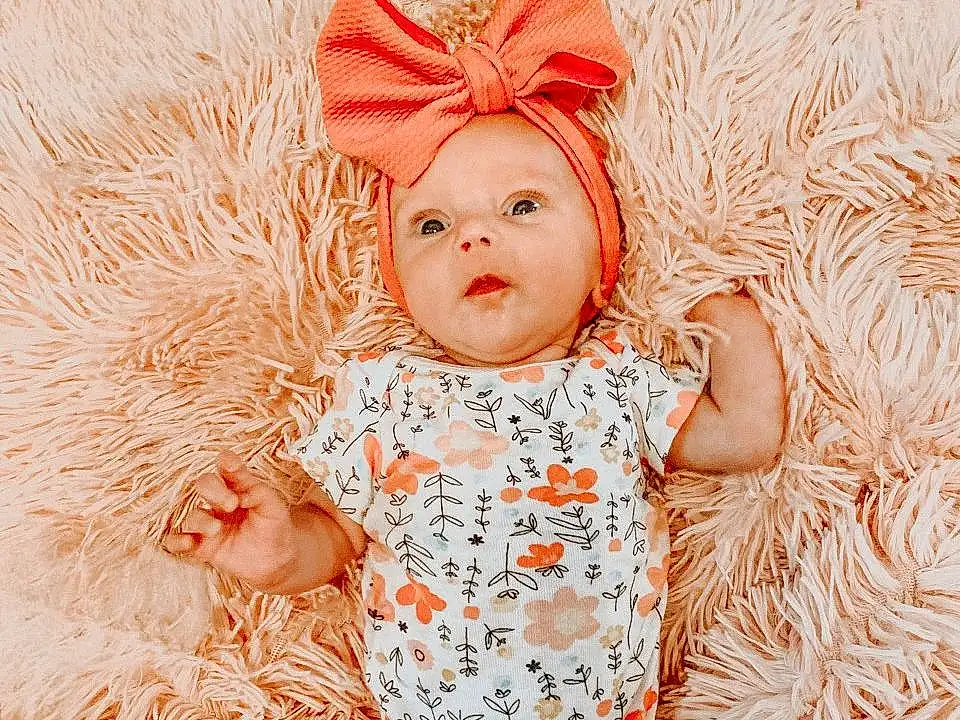 Skin, Eyes, Baby & Toddler Clothing, Textile, Happy, Pink, Baby, Toddler, People In Nature, Pattern, Child, Peach, Fashion Accessory, Art, Grass, Costume Hat, Thigh, Stock Photography, Furry friends, Human Leg, Person