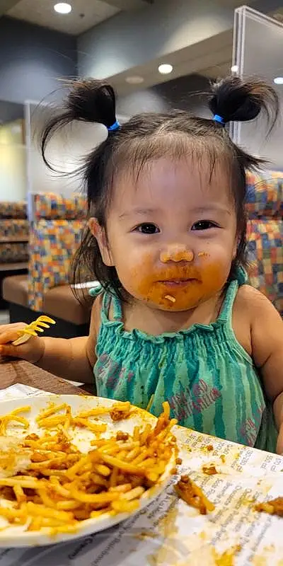 Face, Food, Head, Photograph, Table, Eyelash, Yellow, Chair, Food Craving, Happy, French Fries, Sharing, Toddler, Cuisine, Fun, Dish, Baby, Child, Fried Food, Person