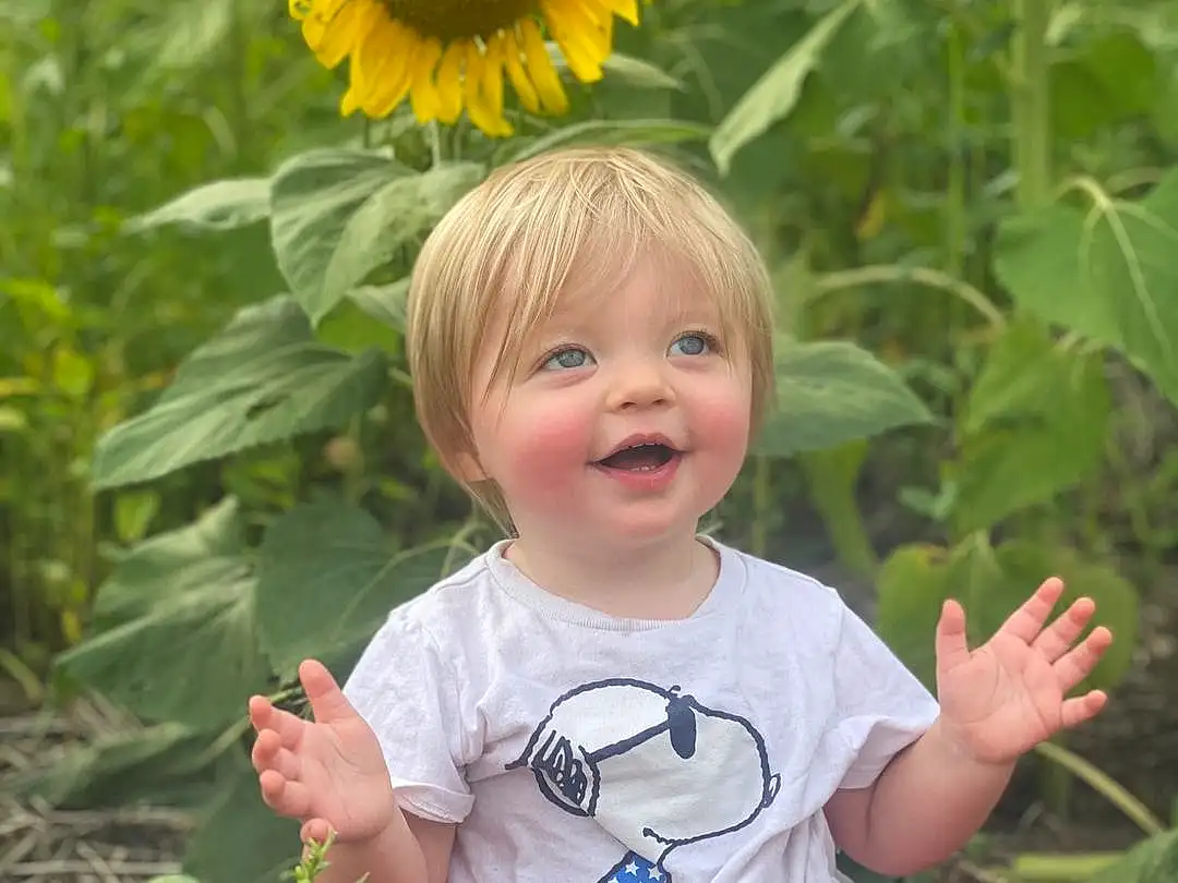 Smile, Skin, Head, Plant, Flower, Hairstyle, Photograph, Eyes, Facial Expression, People In Nature, Green, Leaf, Baby & Toddler Clothing, Grass, Botany, Happy, Standing, Yellow, Person