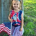Hairstyle, Plant, Dress, Standing, Pink, Baby & Toddler Clothing, Grass, People In Nature, Happy, Day Dress, Waist, Flag Of The United States, Summer, Electric Blue, Toddler, Pattern, Child, Lawn, Fun, Plaid, Person, Joy