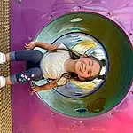 Smile, Purple, Pink, Playground, Leisure, Happy, Fun, Recreation, Circle, Automotive Tire, Child, Electric Blue, Automotive Wheel System, Paint, Toddler, Play, Auto Part, Outdoor Play Equipment, Magenta, Chute, Person, Joy