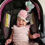 Facial Expression, Smile, Comfort, Baby Carriage, Baby & Toddler Clothing, Baby, Pink, Car Seat, Toddler, Fun, Auto Part, Thigh, Lap, Happy, Child, Baby Products, Sitting, Fashion Accessory, Family Car, Magenta, Person, Joy, Headwear