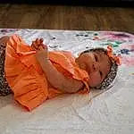 Skin, Head, Eyes, Comfort, Baby & Toddler Clothing, Orange, Textile, Baby, Finger, Toddler, Wood, Linens, Child, Pattern, Fun, Sitting, Bedtime, Fashion Accessory, Person, Headwear
