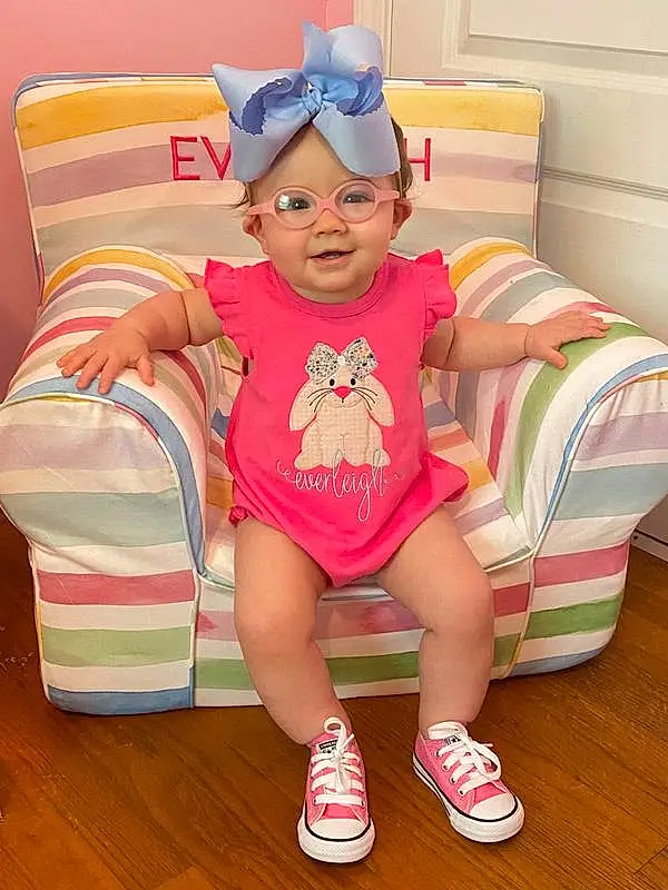 Baby & Toddler Clothing, Pink, Eyewear, Thigh, Happy, Comfort, Toddler, Leisure, Magenta, Child, Chair, Fun, Human Leg, Event, Sitting, Knee, Room, Couch, T-shirt, Foot, Person, Headwear