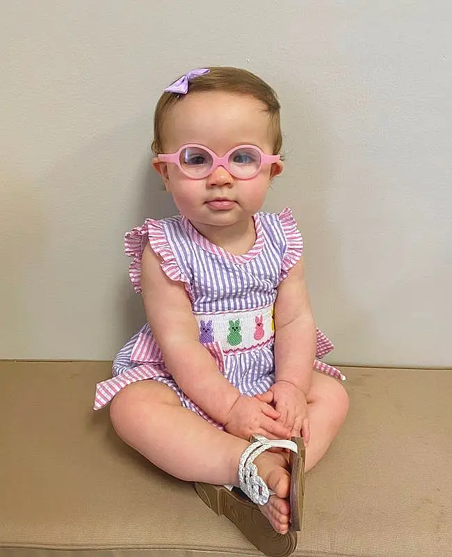 Face, Hair, Glasses, Lip, Dress, Baby & Toddler Clothing, Eyewear, Sleeve, Baby, Vision Care, Pink, Sunglasses, Day Dress, One-piece Garment, Goggles, Smile, Happy, Toddler, Magenta, Pattern, Person
