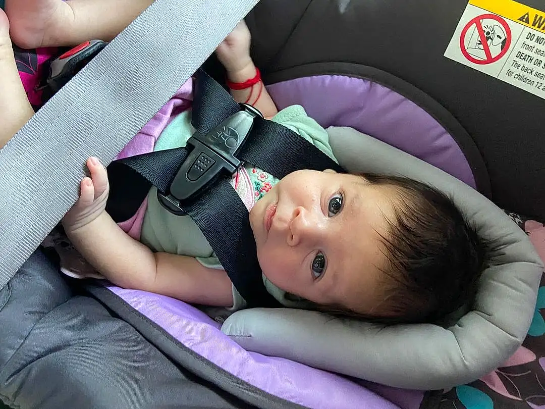 Skin, Comfort, Purple, Baby Carriage, Seat Belt, Gesture, Car Seat, Finger, Pink, Violet, Toddler, Baby In Car Seat, Baby, Auto Part, Baby Products, Grass, Baby & Toddler Clothing, Child, Fashion Accessory, Person