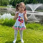Clothing, Water, Plant, People In Nature, Botany, Baby & Toddler Clothing, Happy, Tree, Grass, Toddler, Fun, Fountain, Summer, Leisure, Smile, Meadow, Child, Recreation, Grassland, Person, Joy