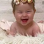 Face, Smile, White, Plant, Lei, Happy, Toddler, Flower, Baby, Headpiece, Baby & Toddler Clothing, Headband, Jewellery, Event, Fashion Accessory, Child, Crown, People In Nature, Hair Accessory, Peach, Person, Headwear
