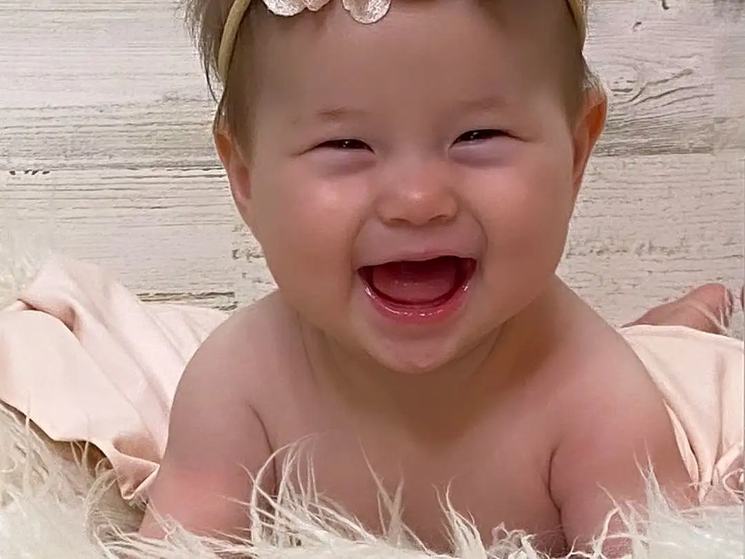 Face, Smile, White, Plant, Lei, Happy, Toddler, Flower, Baby, Headpiece, Baby & Toddler Clothing, Headband, Jewellery, Event, Fashion Accessory, Child, Crown, People In Nature, Hair Accessory, Peach, Person, Headwear