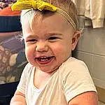 Nose, Cheek, Skin, Head, Smile, Mouth, Happy, Iris, Toddler, Baby, Child, Fun, Headpiece, Headband, Event, Sitting, Fashion Accessory, Baby & Toddler Clothing, Laugh, Costume Hat, Person, Joy