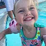Face, Smile, Water, Skin, Head, Mouth, Blue, Happy, Iris, Pink, Toddler, Fun, Leisure, Recreation, Child, Swimming Pool, Play, Bathing, Personal Protective Equipment, Vacation, Person, Joy