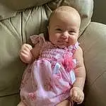 Face, Cheek, Skin, Head, Lip, Chin, Smile, Arm, Eyes, Mouth, Comfort, Baby & Toddler Clothing, Neck, Sleeve, Dress, Finger, Pink, Thigh, Baby, Thumb, Person