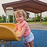 Sky, Plant, Smile, Tree, Pink, Toddler, Leisure, Grass, Baby & Toddler Clothing, Outdoor Play Equipment, City, Recreation, Outdoor Furniture, Shade, Fun, Chute, Playground, Human Settlement, Blond, Playground Slide, Person, Joy
