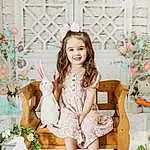 Smile, Plant, White, Dress, Happy, Pink, Fawn, Grass, Toddler, Beauty, Fashion Design, Child, Formal Wear, Pattern, Event, Sitting, Brown Hair, Peach, Spring, Floral Design, Person, Joy