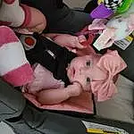 Hand, Arm, Baby Carriage, Comfort, Gesture, Pink, Finger, Car Seat, Baby, Toddler, Lap, Nail, Baby Products, Thigh, Stuffed Toy, Thumb, Auto Part, Child, Human Leg, Knee, Person, Headwear