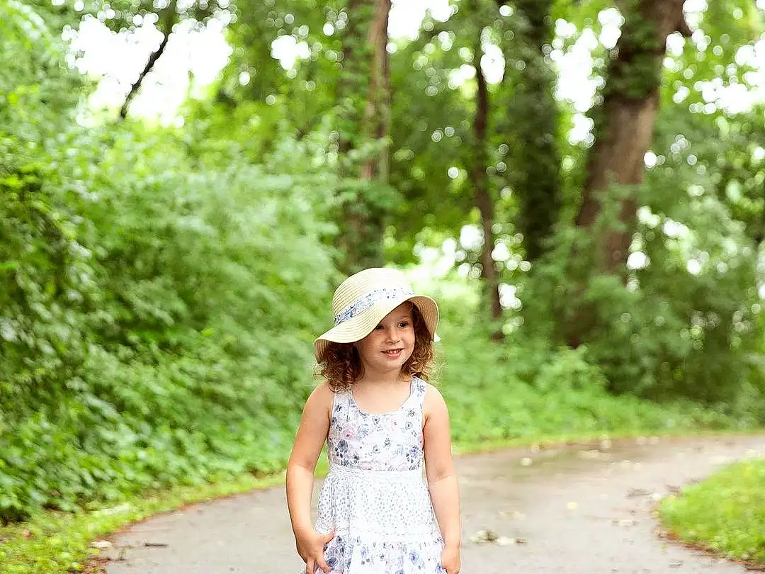 Plant, Green, Dress, Tree, People In Nature, Smile, Waist, Grass, Happy, Summer, Toddler, Day Dress, Leisure, Recreation, Pattern, Forest, Road, Plaid, Child, Fashion Accessory, Person, Joy, Headwear
