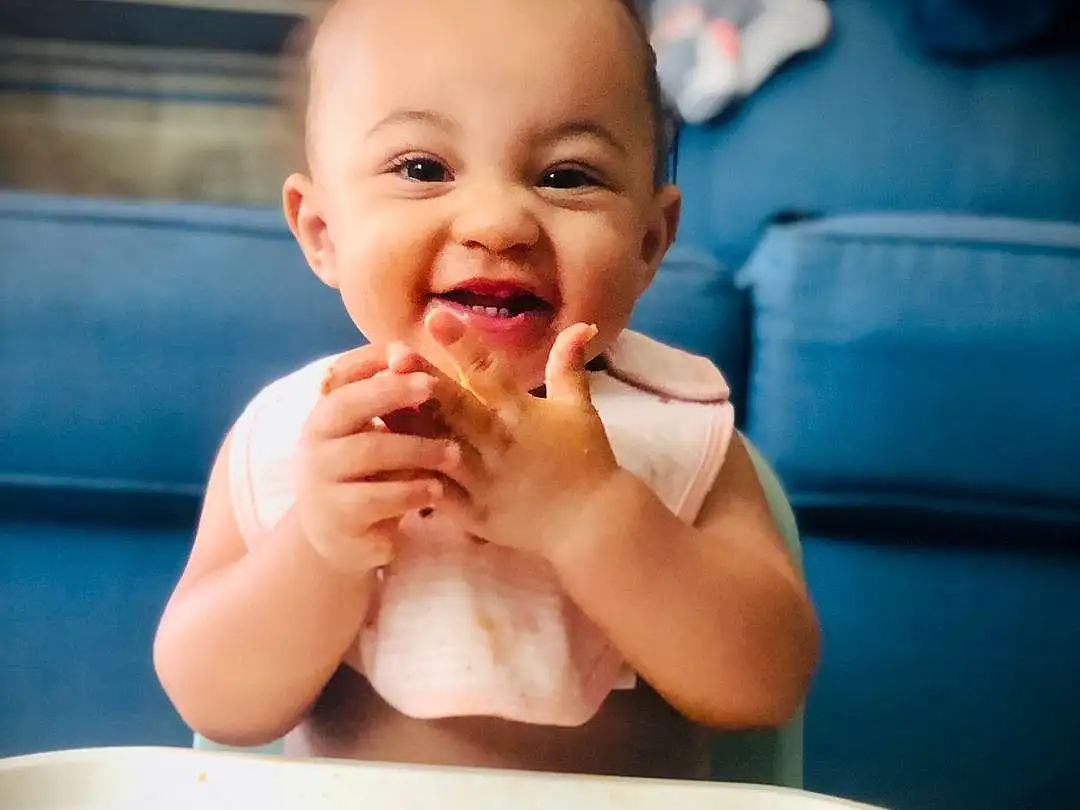 Food, Smile, Hand, Baby Playing With Food, Blue, Tableware, Food Craving, Gesture, Finger, Toddler, Baby, Cuisine, Dish, Biting, Fun, Thumb, Happy, Child, Ingredient, Sweetness, Person
