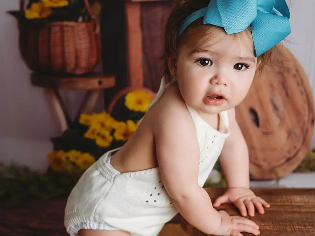 Face, Skin, Head, Arm, Eyes, Plant, Human Body, Flash Photography, Baby & Toddler Clothing, Iris, Flower, Baby, Thigh, Fawn, Happy, Toddler, Child, Foot, Human Leg, Chair, Person, Headwear