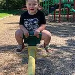 Shorts, Plant, Grass, Leisure, Public Space, Recreation, Toddler, Fun, T-shirt, Tree, Human Settlement, Walking Shoe, Asphalt, Outdoor Play Equipment, City, Soil, Elbow, Child, Pipe, Happy, Person